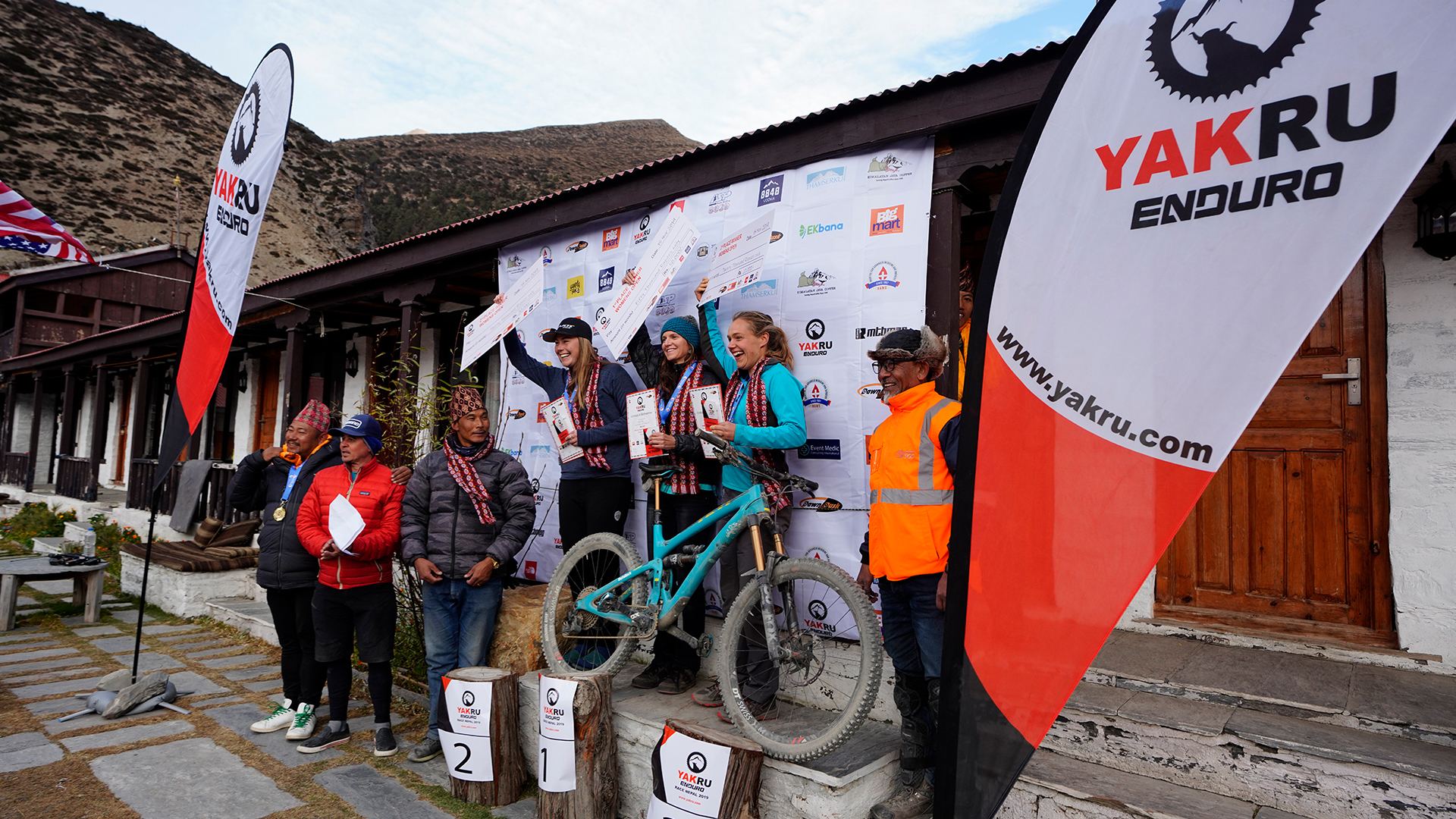 Riders on the podium in front of the Yak Ru banner